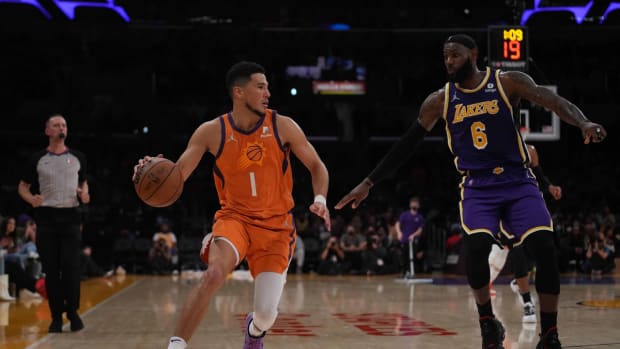 Oct 22, 2021; Los Angeles, California, USA; Phoenix Suns guard Devin Booker (1) is defended by Los Angeles Lakers forward LeBron James (6) in the second half at Staples Center. The Suns defeated the Lakers 115-105. Mandatory Credit: Kirby Lee-USA TODAY Sports